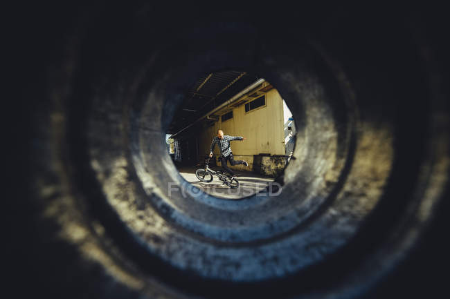 Shot through tube of BMX rider — Stock Photo