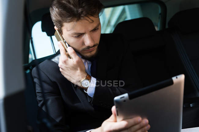 Busy man with gadgets — Stock Photo