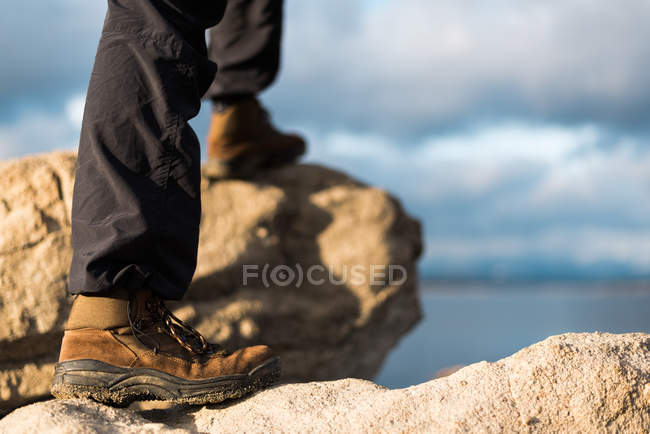 Crop male standing on stones — Stock Photo