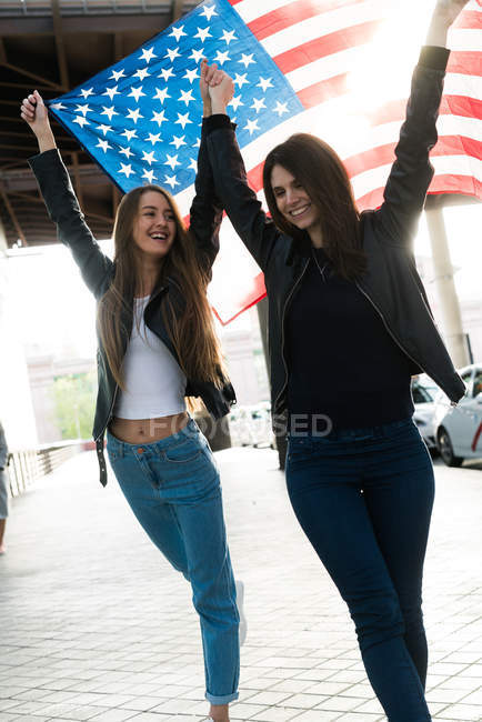 Women with USA flag on  parking — Stock Photo