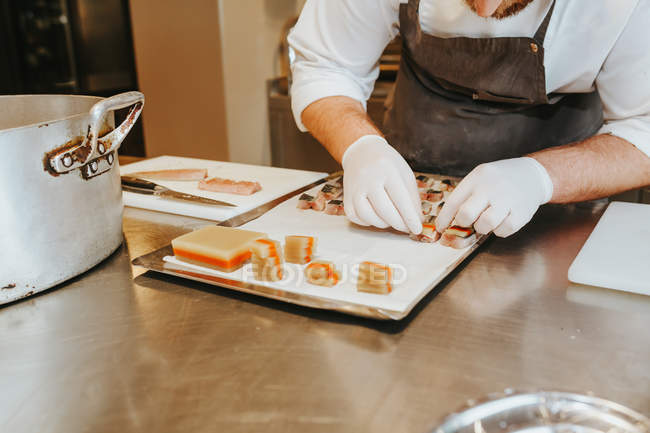 Cooks hands preparing sushi — Stock Photo