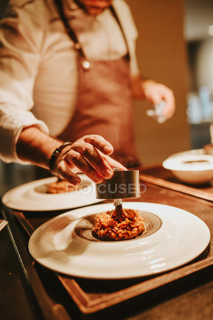 Cook decorating dish — Stock Photo