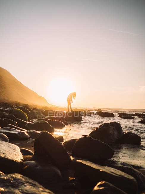 Silueta de mujer en la playa . - foto de stock