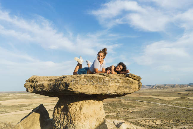 Захоплені жінки лежать на скелі — стокове фото