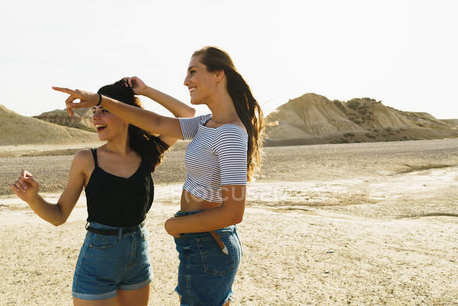 Women posing in sandy hills — Stock Photo