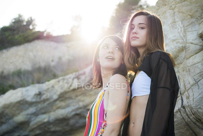 Stylish girls posing on beach — Stock Photo