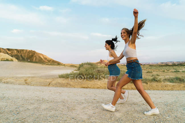 Mulheres felizes andando na colina — Fotografia de Stock