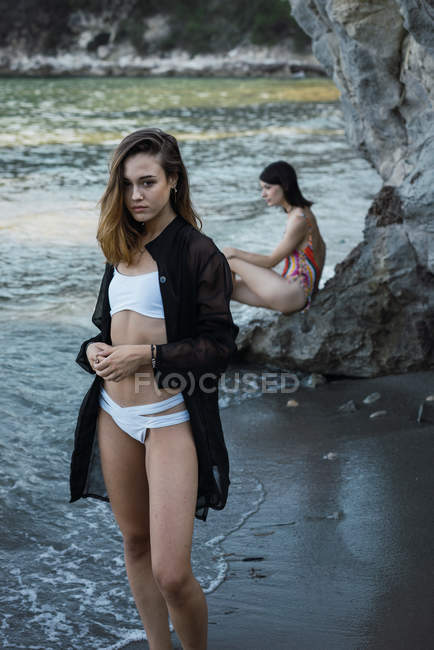 Stylish girls posing on beach — Stock Photo