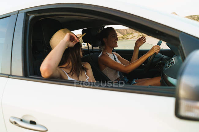 Pretty women riding car — Stock Photo