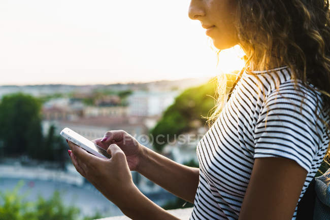 Crop girl in street with phone — Stock Photo