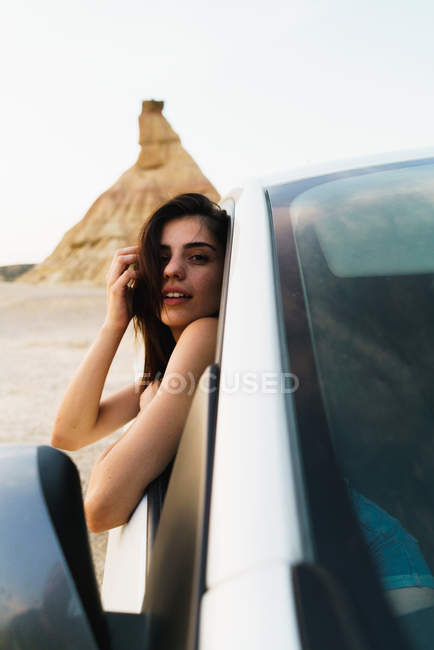 Woman hanging out of car — Stock Photo