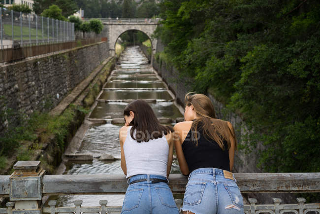 Young girls posing on bridge — Stock Photo