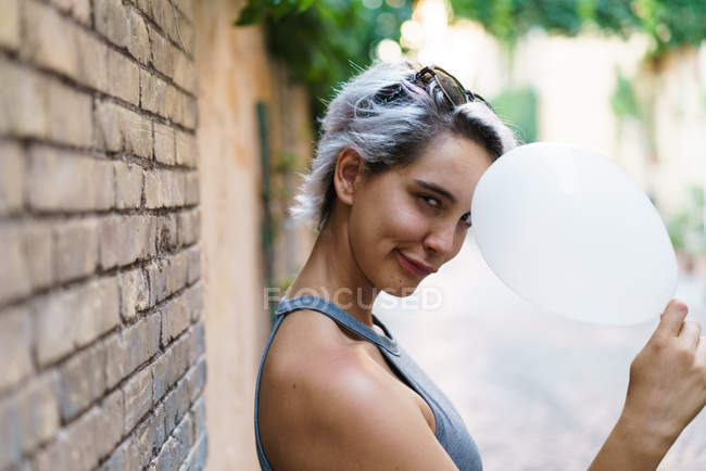 Charming woman posing with balloon — Stock Photo