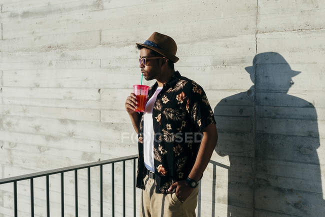 Thinking man standing and drinking — Stock Photo