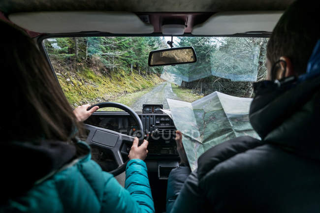 Couple driving on rural road — Stock Photo