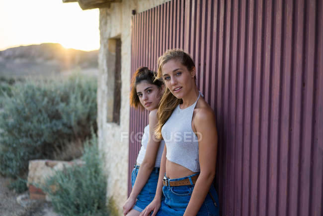Women standing at wall together — Stock Photo
