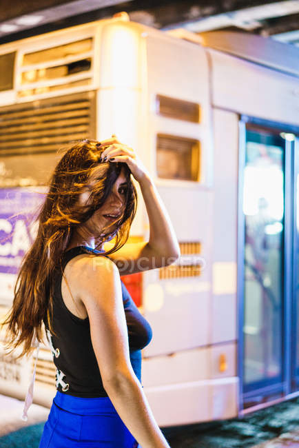 Cheerful woman covering face with hair — Stock Photo