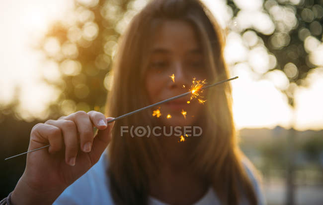 Woman with sparkling light — Stock Photo