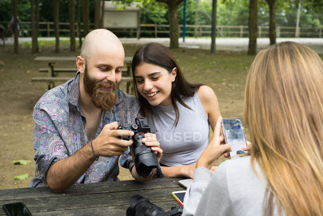 Friends with camera in park — Stock Photo