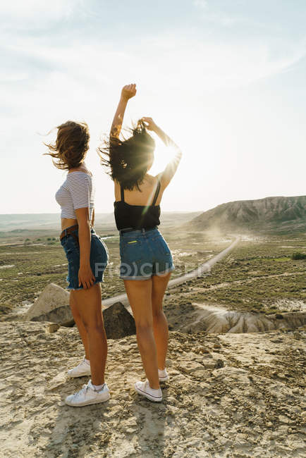 Cheerful women standing on cliff — Stock Photo