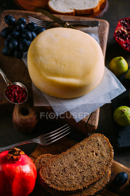 Cheese with some fruit and bread — Stock Photo