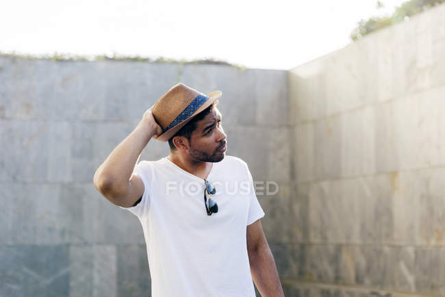 Mann posiert und hält Hut auf Straße — Stockfoto