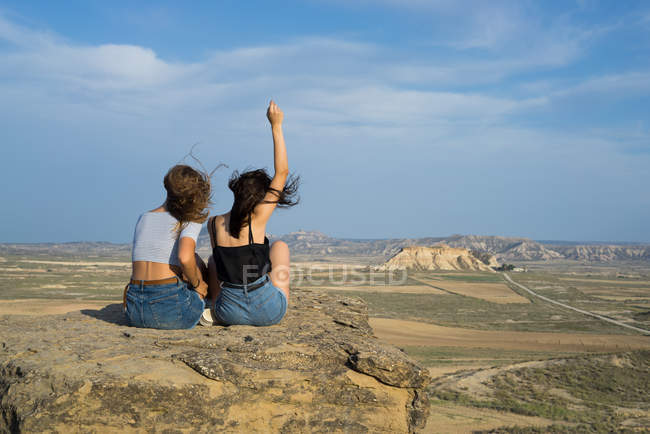 Excited women lying on cliff — Stock Photo
