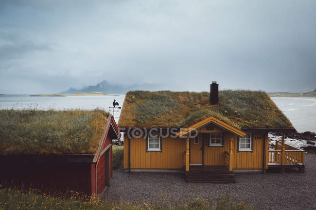 Houses on misty island — Stock Photo