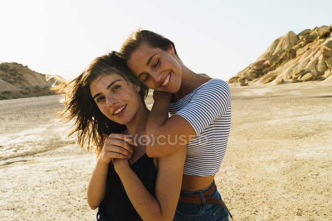 Women posing in sandy hills — Stock Photo