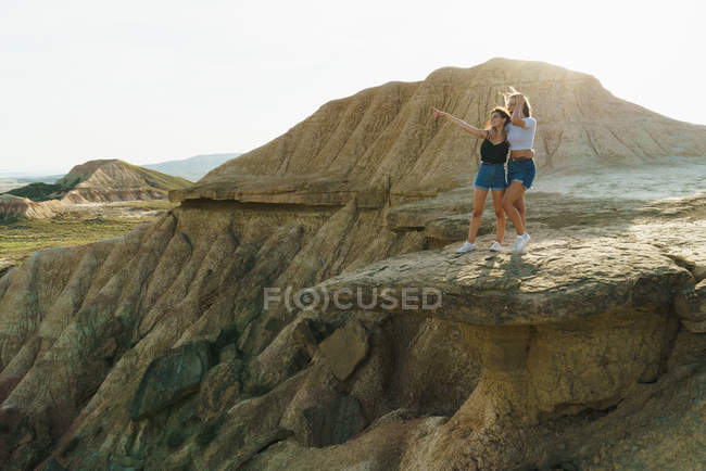 Excited women standing on cliff — Stock Photo