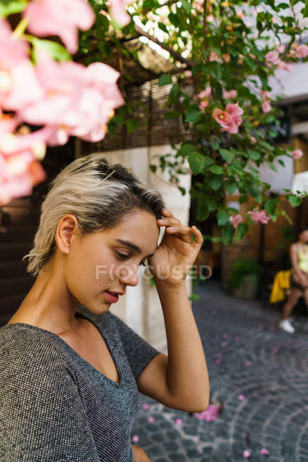 Smiling woman at blooming tree — Stock Photo