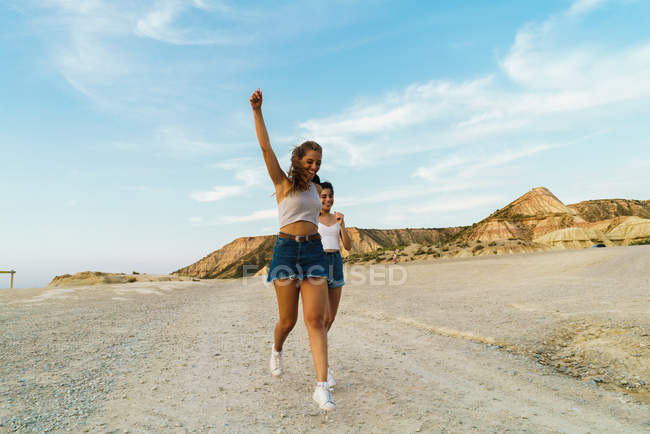 Happy women walking on hill — Stock Photo