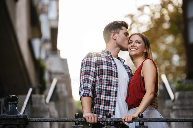 Young loving couple kissing in the street. — Stock Photo