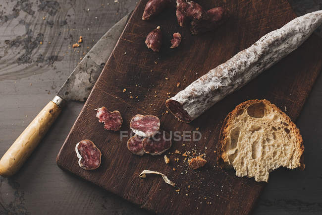 Catalan fuet on wooden board — Stock Photo