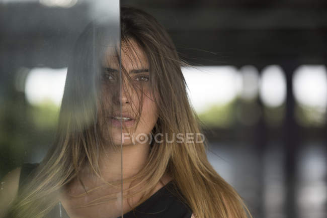 Woman behind glass — Stock Photo