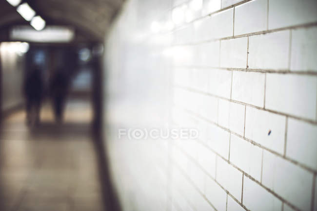 Textured ceramic wall made of white tiles in subway — Stock Photo