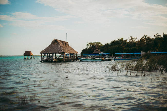 Landscape of resort buildings on water and moored boats — Stock Photo