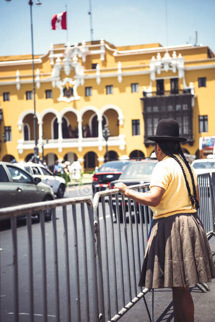 Back view of woman in hat looking at Town Hall of Lima — Stock Photo