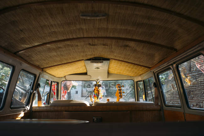 Interior of empty vintage van with guitar at front seat — Stock Photo