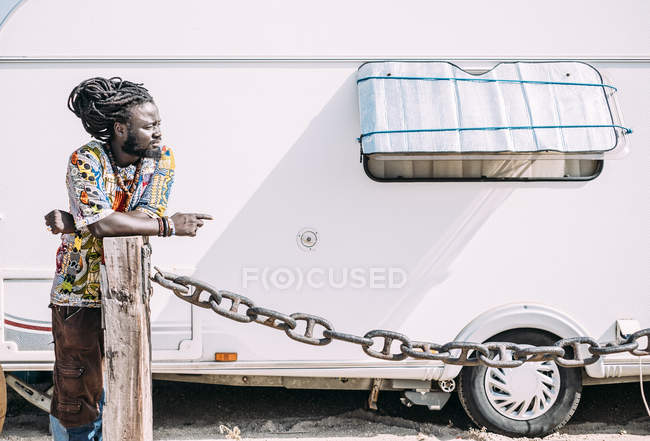 Man standing near trailer and looking away. — Stock Photo