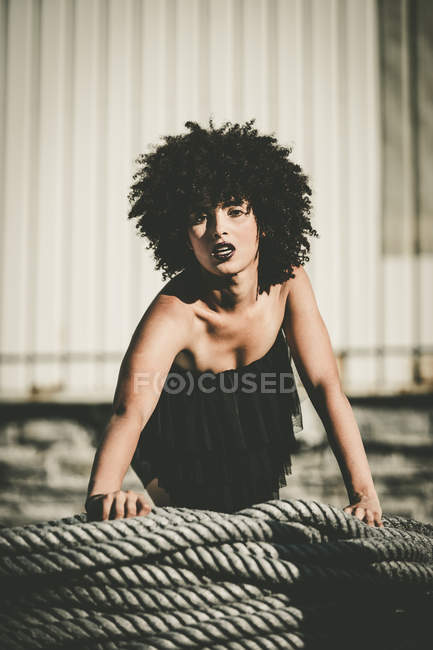 Brunette girl with afro posing on ropes — Stock Photo
