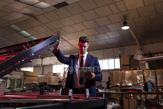 Formal man with tablet checking inspecting workshop. — Stock Photo