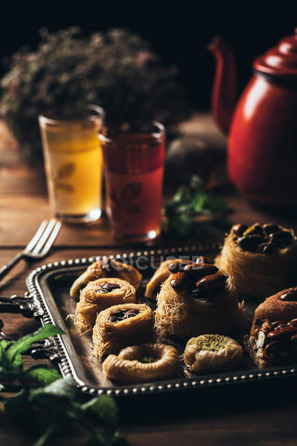 Yummy syrian pastry with mint by glasses of tea. — Stock Photo