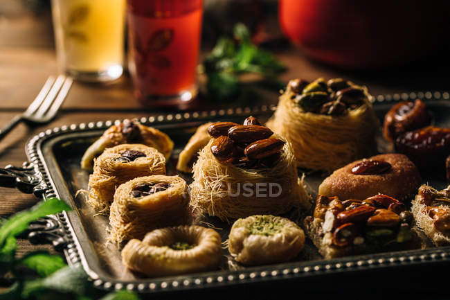 Still life of syrian desserts on plate and glasses of tea. — Stock Photo