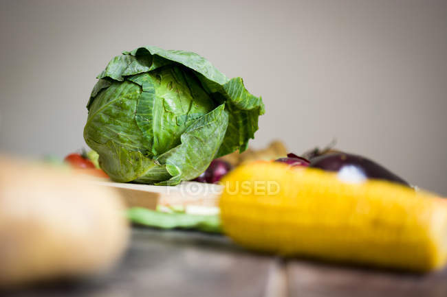 Close-up of cabbage and vegetables on grey background — Stock Photo