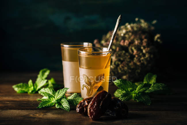Tasty arabic tea with mint on wooden table. — Stock Photo