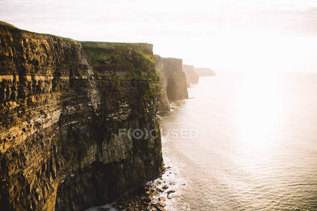 Plumb cliff over calm sescape — Stock Photo
