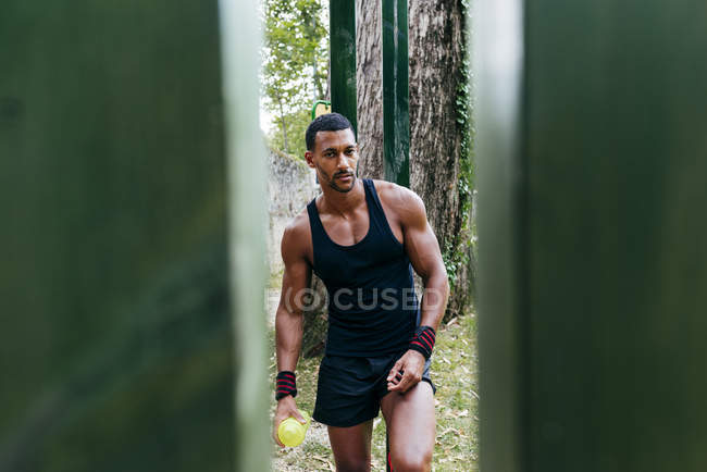 Fit man standing with bottle — Stock Photo