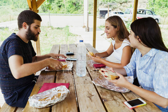 Friends having meal while traveling — Stock Photo