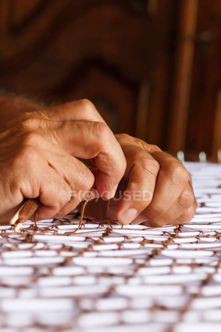 Mãos masculinas de colheita trabalhando com tapeçaria — Fotografia de Stock